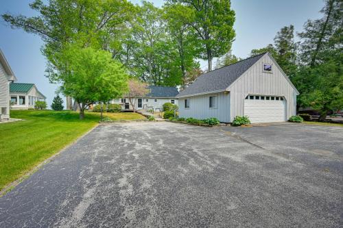a house with a driveway with a garage at Vibrant Waterfront Vacation Rental on Lake Huron! in Tawas City