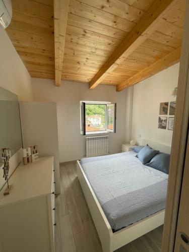 a bedroom with a bed and a wooden ceiling at Da Pippo in Moneglia
