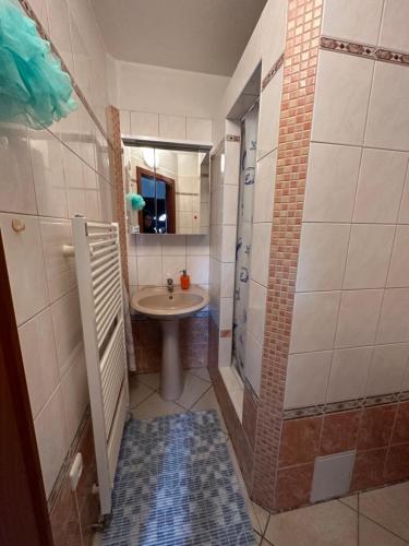 a small bathroom with a sink and a mirror at Domeček u Terčina Údolí in Nové Hrady