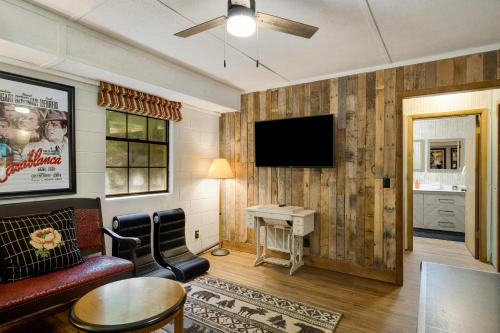 a living room with a couch and a tv on a wall at A Little Leeway in Ellijay
