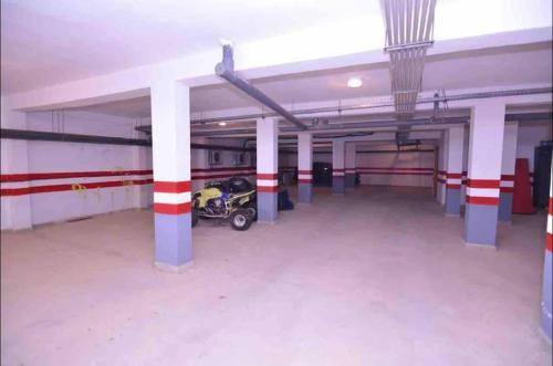 a empty parking garage with a motorcycle parked in it at Appartement de vacances piscines et plage in Tangier