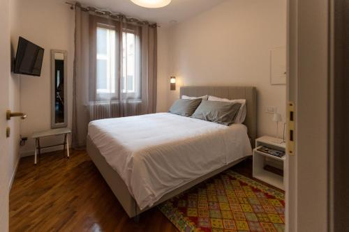 a bedroom with a large bed and a window at La casa del Vescovo in Imola