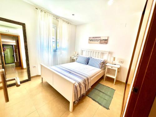 a bedroom with a white bed and a window at Condado de alhama NARANJOS 8 SV/92 in El Romero