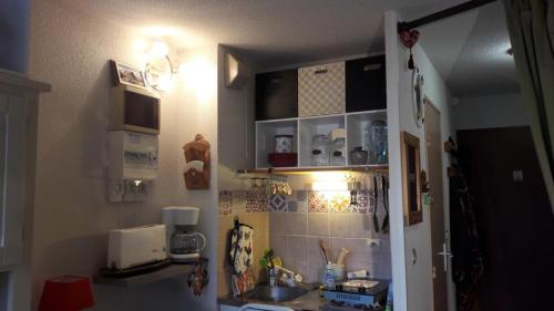 una pequeña cocina con fregadero y encimera en Les Montagnes, en Bellevaux