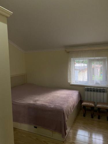 a small bedroom with a bed and a window at Green House in Dilijan