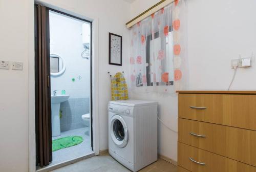 a washing machine in a bathroom with a shower at apartment close to beach and stJulians in Naxxar
