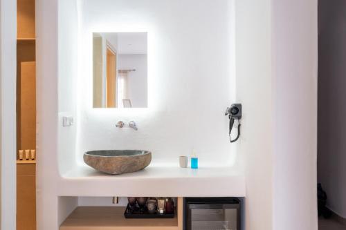 a bathroom with a sink with a stone bowl at Liana sunset in Mýkonos City