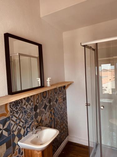 a bathroom with a sink and a mirror at The Pink House in Faja Grande