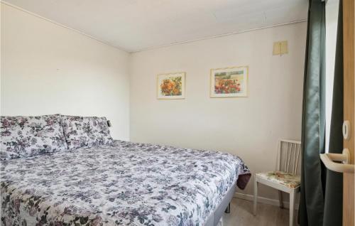 a bedroom with a bed with a floral bedspread at Pet Friendly Home In Slagelse With House Sea View in Slagelse