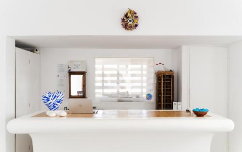 a kitchen with white walls and a white counter top at Rhenia Hotel in Tourlos