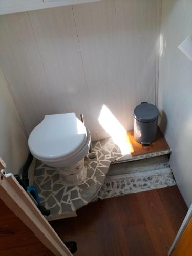 a bathroom with a toilet with a light on the floor at Bateau PEARL in Rouen