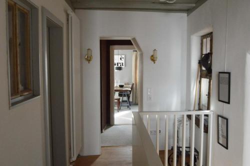 a hallway with a stairway leading to a dining room at Ferienwohnung Winzerloft in Sulzfeld am Main