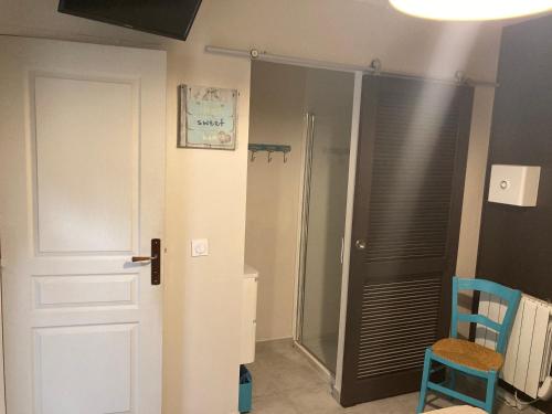 a bathroom with a shower and a toilet and a door at Les hauts de Frisella in Monacia-dʼAullène