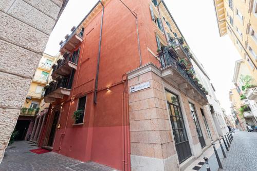 um edifício vermelho no lado de uma rua em Residenza Catullo - Apartments em Verona