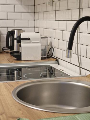 a kitchen counter with a sink and a toaster at Quiet Center in Sremska Mitrovica