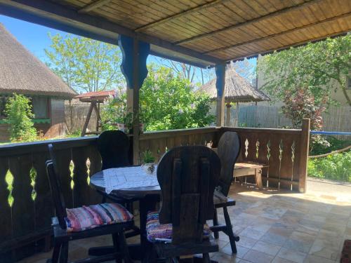a patio with a table and chairs on a deck at Casa Soarelui in Murighiol