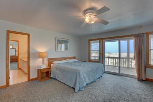 a bedroom with a bed and a ceiling fan at Play-N-Hooky Too #9-2 in Avon