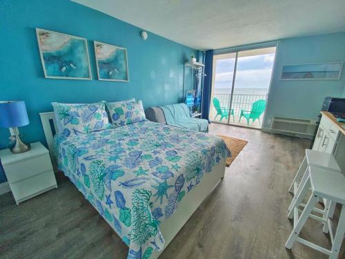 a bedroom with a bed and a view of the ocean at Sea Dip Resort Studios! in Daytona Beach