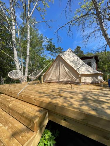 a yurt with two chairs on a wooden deck at Glamping Tent Mariehamn in Mariehamn