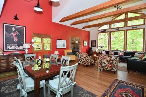 a living room with red walls and a table and chairs at Healing House - Healing Escape in Berkeley Springs