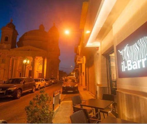 a restaurant with a table outside of a building at Central, Fully Equipped Modern Apartment - 2 in Mġarr