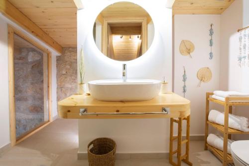 a bathroom with a sink and a mirror at Pnoes Villas Vasiliki Lefkada in Vasiliki