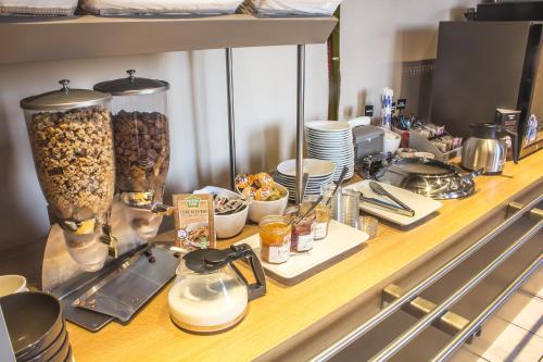 a counter with food and other items on it at Hotel Inn Design Montluçon in Montluçon