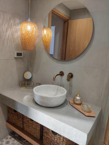 a bathroom with a bowl sink and a mirror at Lipsi Sands in Lipsoi