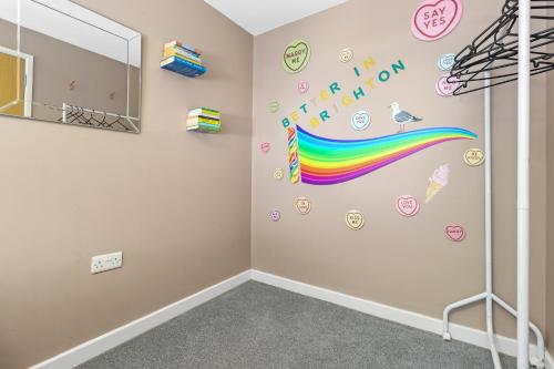a room with a rainbow wall and a mirror at Modern House with Parking Buisness and Leisure in Brighton & Hove