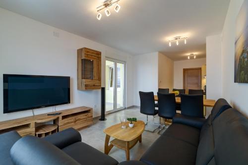 a living room with a couch and a flat screen tv at Villa Panorama in Senj