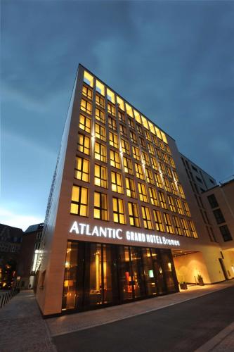 an atlantic grand hotel building with its lights on at ATLANTIC Grand Hotel Bremen in Bremen