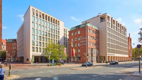 a city street with two tall buildings and a street at ATLANTIC Grand Hotel Bremen in Bremen
