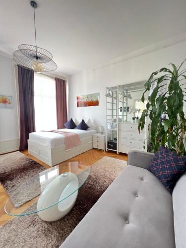 a living room with a bed and a couch and a table at B&B Guest House Du Lac in Montreux