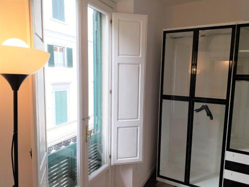 a room with a window and a glass door at Donizetti Elegant Apartment in Florence