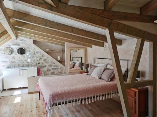 a bedroom with a large bed in a attic at Котор. Потрясающий вид. in Muo