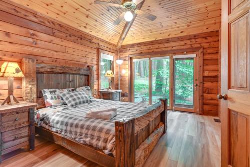 1 dormitorio con 1 cama en una cabaña de madera en Magical Metamora Cottage with Fire Pit, Pond, Deck!, en Metamora