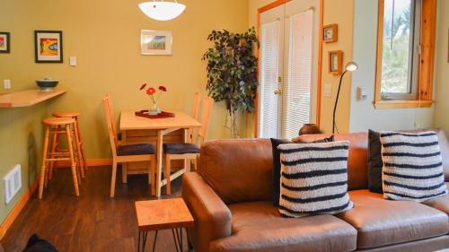 a living room with a couch and a table at Crystal Forest #23 By Bear Country in Sun Peaks