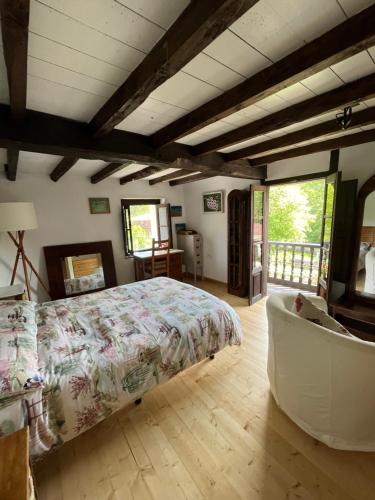 a bedroom with a bed and a couch in a room at La Casina del Corral in Cangas de Onís