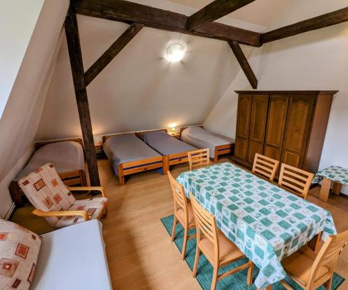 a room with a table and chairs and a room with a bed at Noclegi U Lestka in Lutowiska