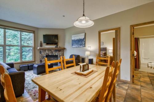 a dining room and living room with a wooden table at Crystal Forest #65 By Bear Country in Sun Peaks