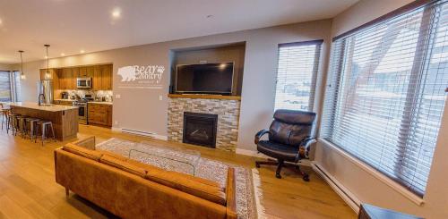a living room with a couch and a fireplace at Echo Landing #12 by Bear Country in Sun Peaks
