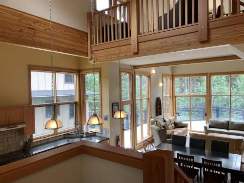 an open living room with a kitchen and a living room at On the Run Chalet by Bear Country in Sun Peaks