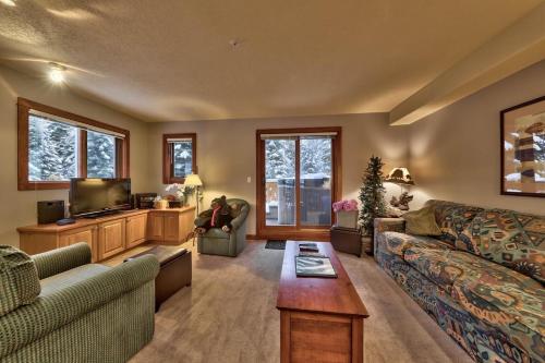 a living room with a couch and a tv at Timberline Village #14 By Bear Country in Sun Peaks