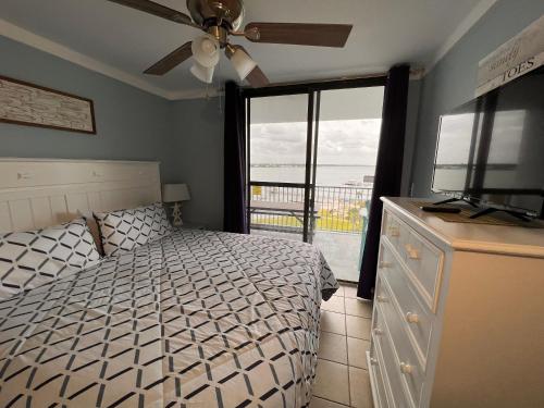 a bedroom with a bed and a view of the ocean at Glimpse of Grace at the Bay in Gulf Shores
