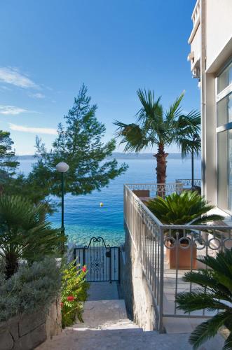 a balcony with a view of the ocean at Hotel Sunceva Postelja Brela in Brela