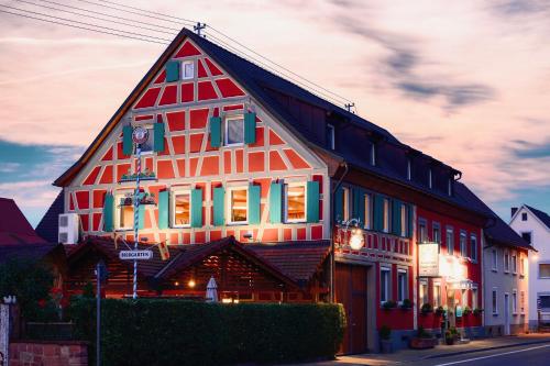 a large red and white building with lights on it at Gasthaus Elsäßer Hof in Kappel-Grafenhausen