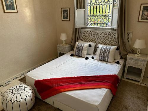 a bedroom with a large bed with a window at Oasis Merasi Marrakech in Marrakech