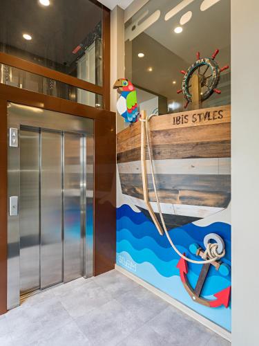 an elevator in a building with a sign that reads his ships at Ibis Styles Lisboa Centro Liberdade NE in Lisbon