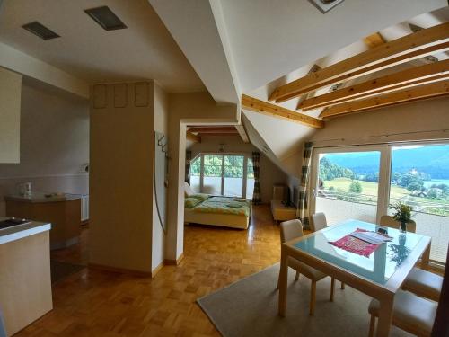 a kitchen and a living room with a table and chairs at Oriana Studios in Bled