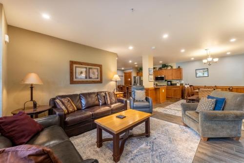 a living room with couches and a table at Springs by Summit County Mountain Retreats in Keystone